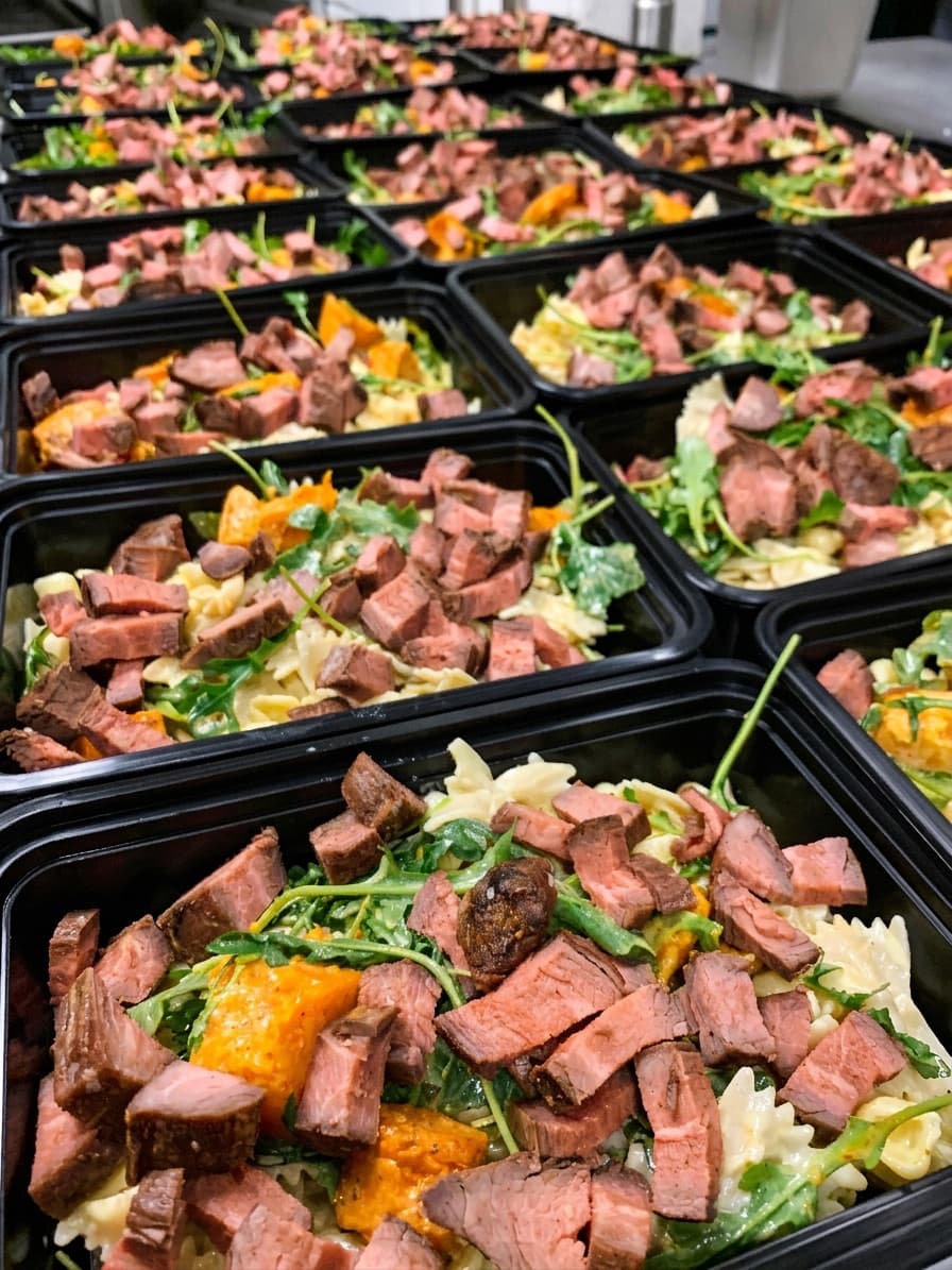 Overhead view of ABLTY performance meal spread prepared for professional athletes