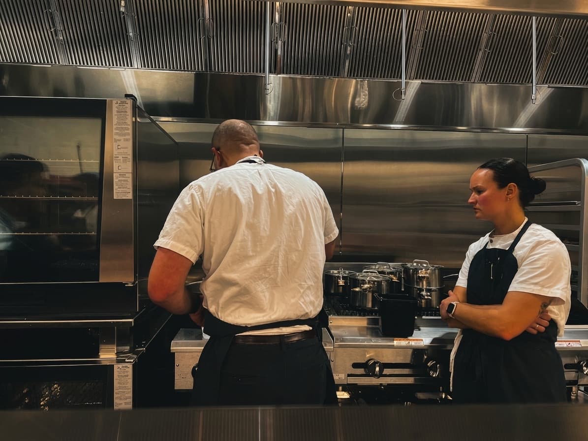 Two chefs collaborating at the pass in ABLTY commercial kitchen
